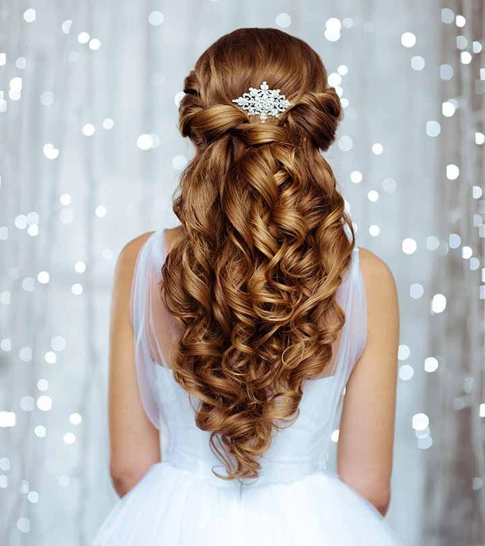 Bride showcasing elegant evening reception wedding hair changes with soft curls