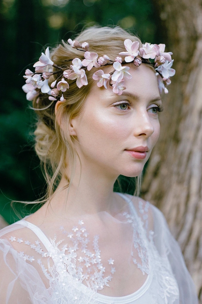 Stunning wedding hairstyle featuring a beautiful floral crown for brides Bride wearing elegant wedding hairstyle with a delicate floral crown