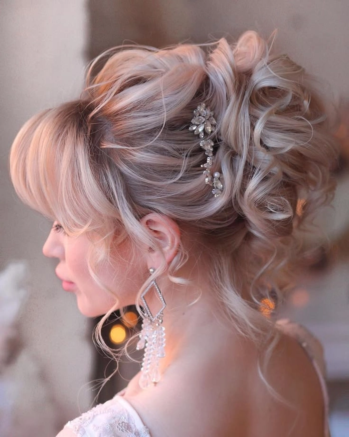 Bride showcasing elegant wedding hair with soft bangs and delicate floral accessories
