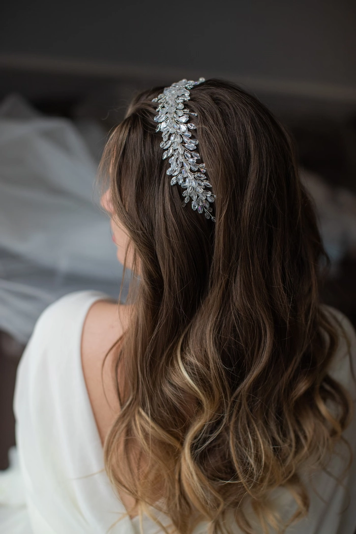 Wedding hairstyle featuring a delicate crystal tiara for a bride Bride with elegant wedding hair and a sparkling crystal tiara