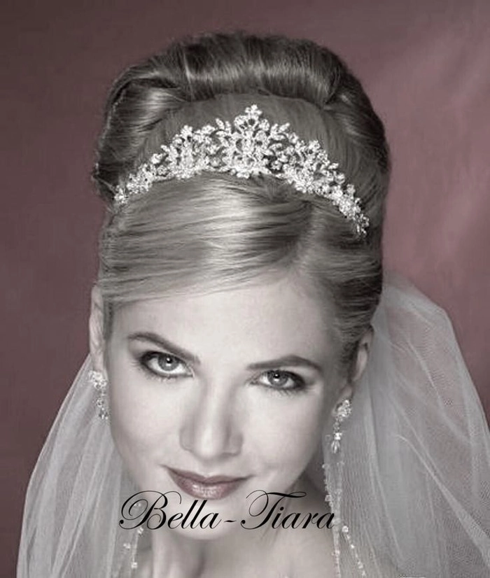 Elegant wedding hair with crystal tiara styled for a classic bridal look Bride showcasing elegant wedding hair with crystal tiara softly placed
