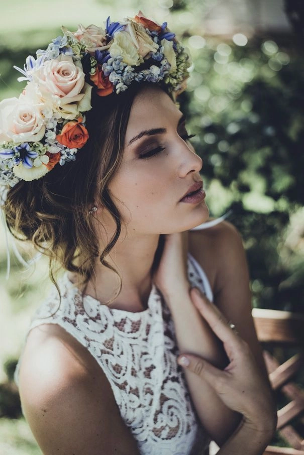 Wedding Hairstyles with Floral Crown Inspiration Image 12 Bride with elegant wedding hairstyle adorned by a delicate floral crown