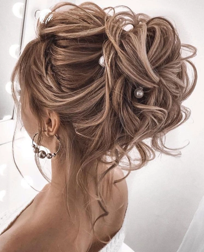 Bride with elegant evening reception wedding hair changes in soft curls