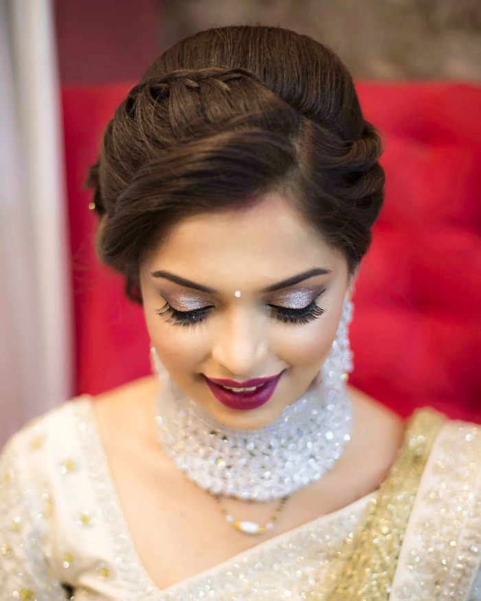 Bride showcasing elegant evening reception wedding hair changes with soft curls