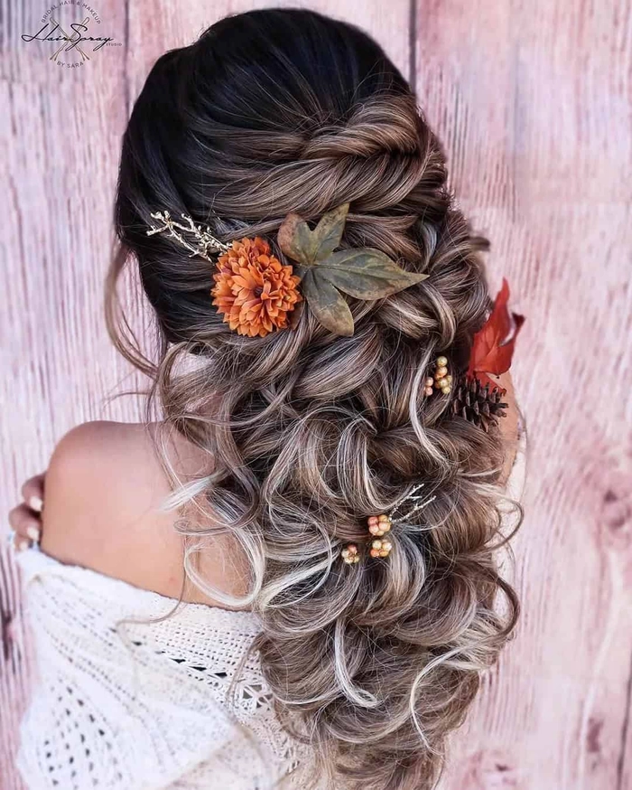 Bride with fall autumn wedding hair adorned with delicate leaves and soft curls