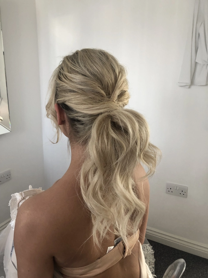 Elegant sleek high ponytail wedding hairstyle perfect for modern brides Bride with a sleek high ponytail wedding hair styled elegantly for a special day