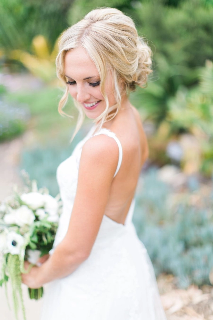Bride with a spring garden wedding floral hair arrangement featuring delicate blossoms