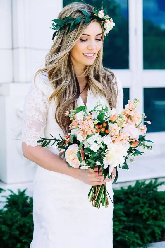 Bride with spring garden wedding floral hair accessory styled in loose waves