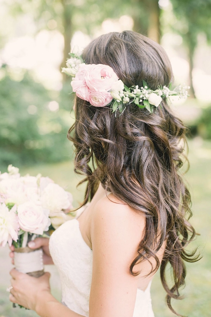 Bride with spring garden wedding floral hair accessory in soft curls