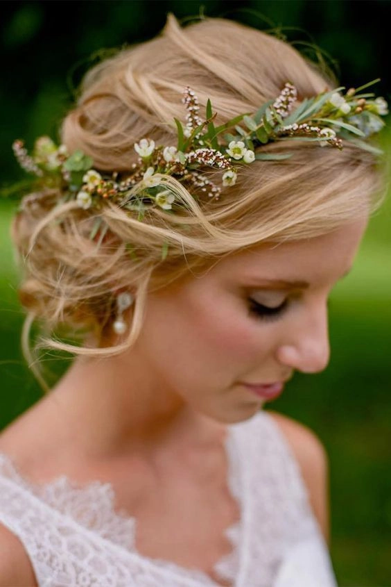 Bride with spring garden wedding floral hair accessories in elegant updo