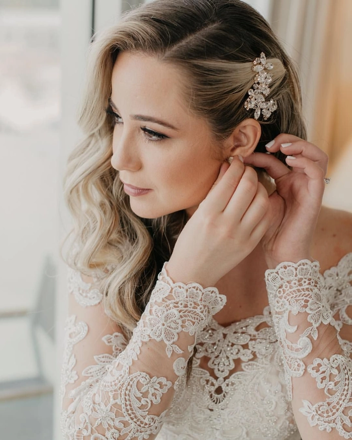 Stunning side swept curly hairstyle perfect for a romantic wedding look Bride showcasing elegant wedding hair side swept curls with delicate floral accents