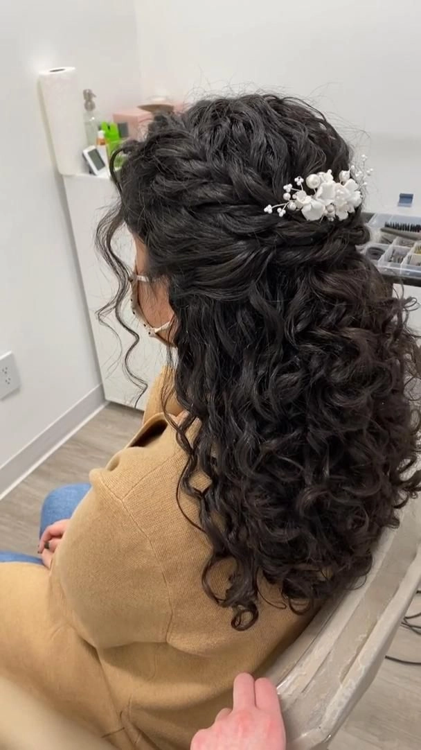 Bridesmaid hair styled beautifully for curly hair with elegant accessories