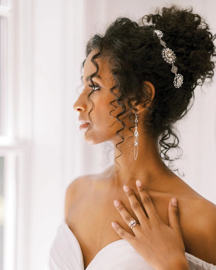 Bridesmaid with beautifully styled curly hair in an elegant updo for a wedding