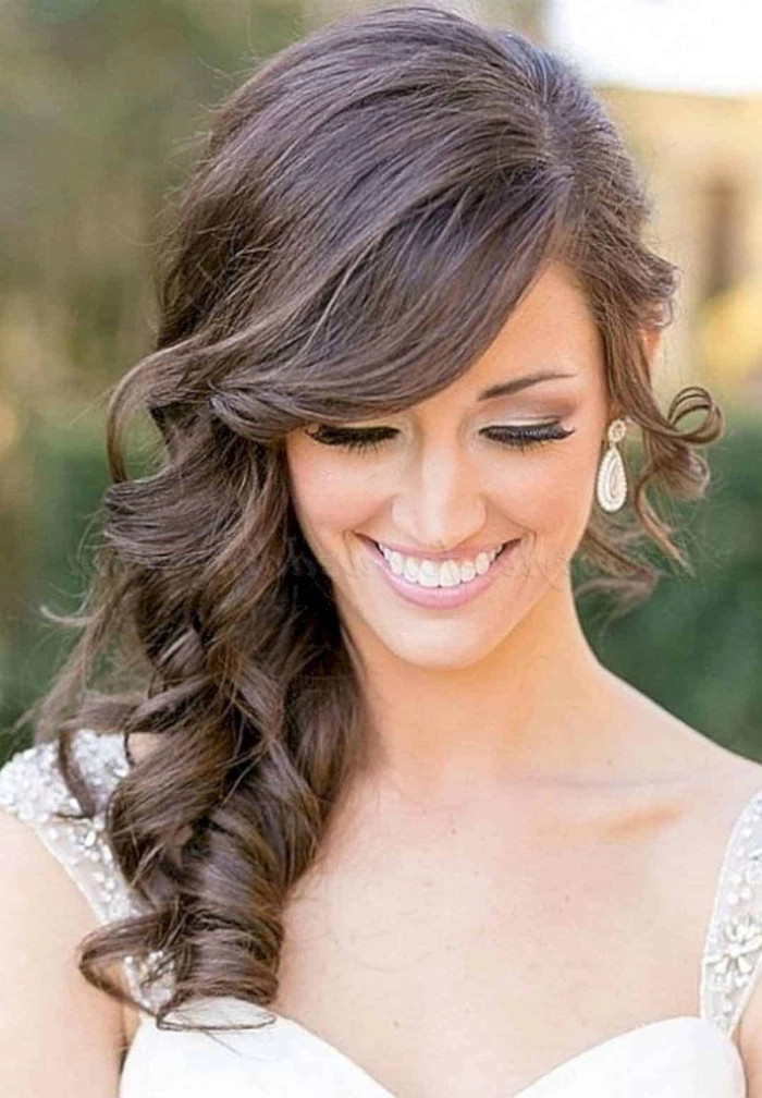 Elegant bridesmaid hairstyles for long hair featuring soft curls and floral accents
