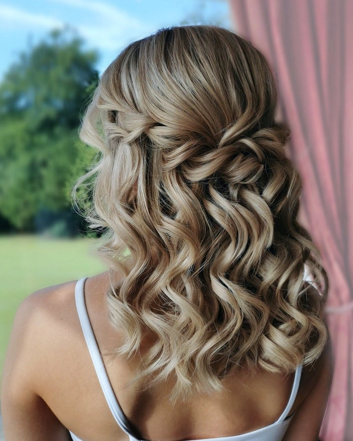 Elegant bridesmaid half up half down styles perfect for wedding day glamour Bridesmaid showcasing elegant half up half down hairstyle with soft curls
