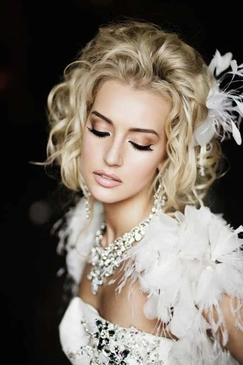 Beautiful bridal hairstyle featuring medium length natural curls and soft waves Medium length curly bridal hair styled elegantly for a wedding day