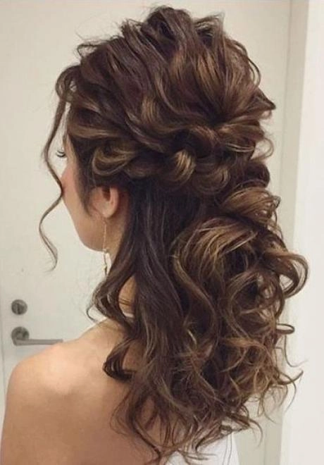 Beautiful curly bridal hairstyle perfect for medium length hair on the special day Medium length curly bridal hair styled elegantly for a wedding day