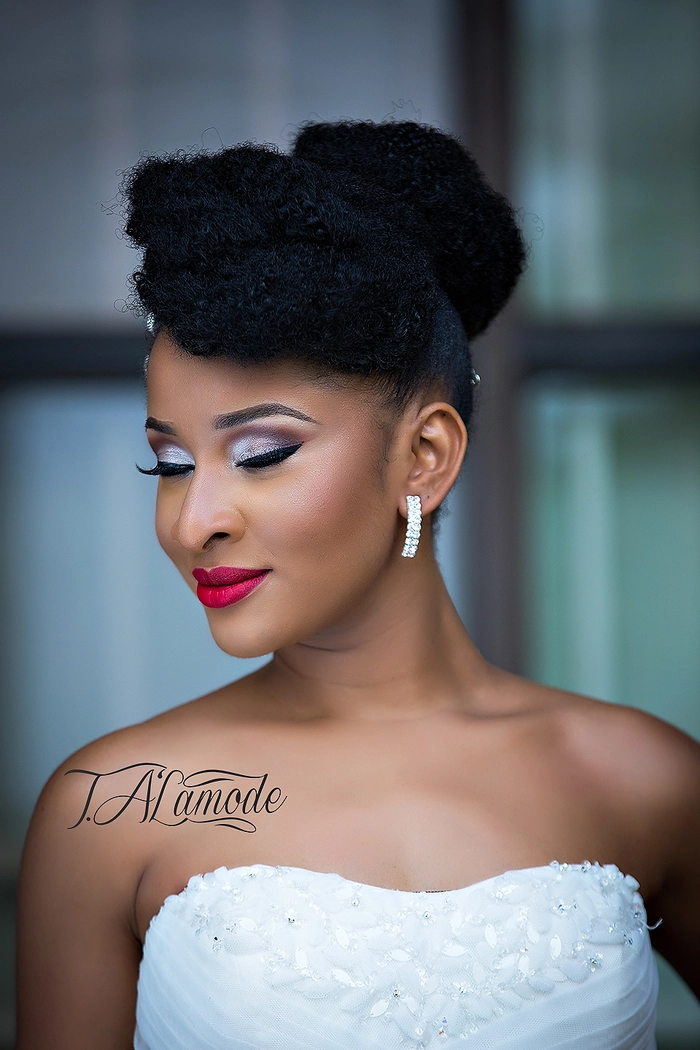 Elegant natural black hair bridal look with soft curls and floral accessories