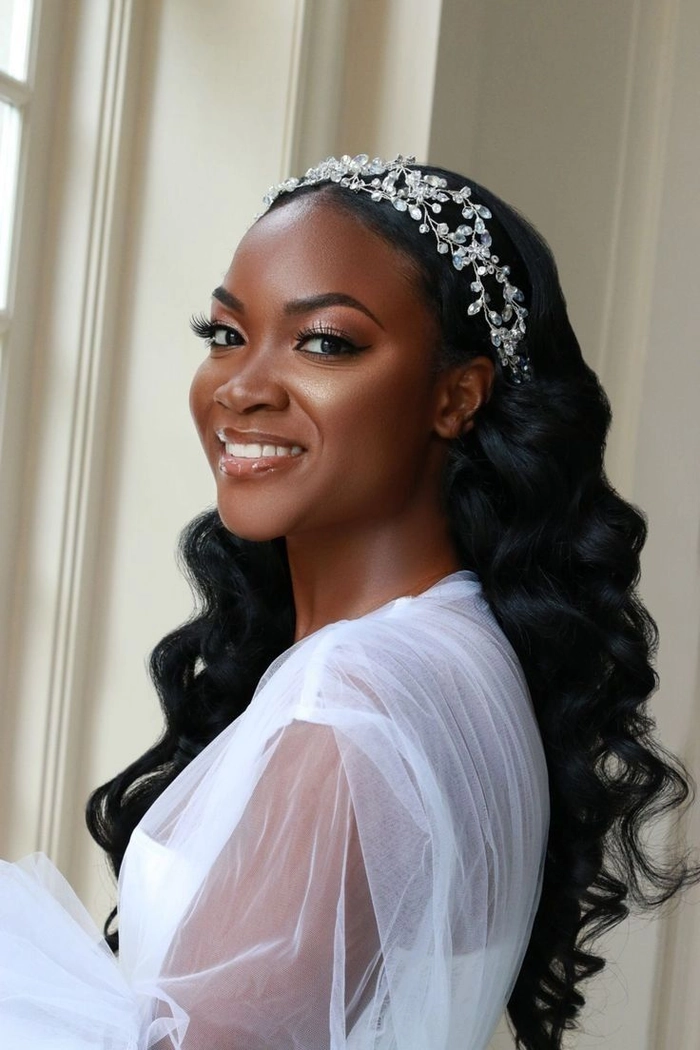Elegant natural black hair bridal look with intricate curls and floral accessories