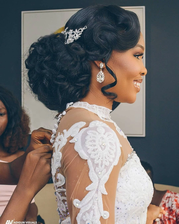 Elegant natural black hair bridal look with intricate styling and floral accents
