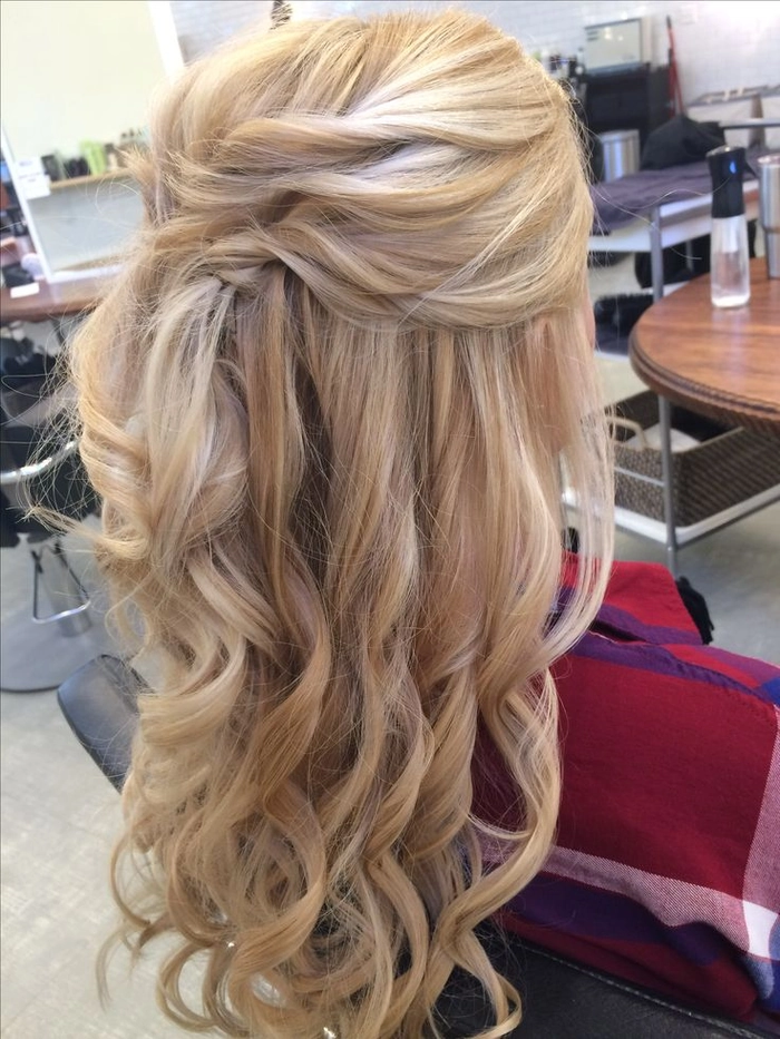Elegant wedding hairstyle featuring blonde balayage curls