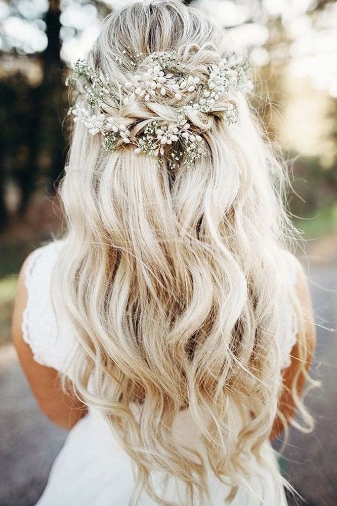 Elegant wedding hair styled for blonde balayage with soft curls and floral accessories