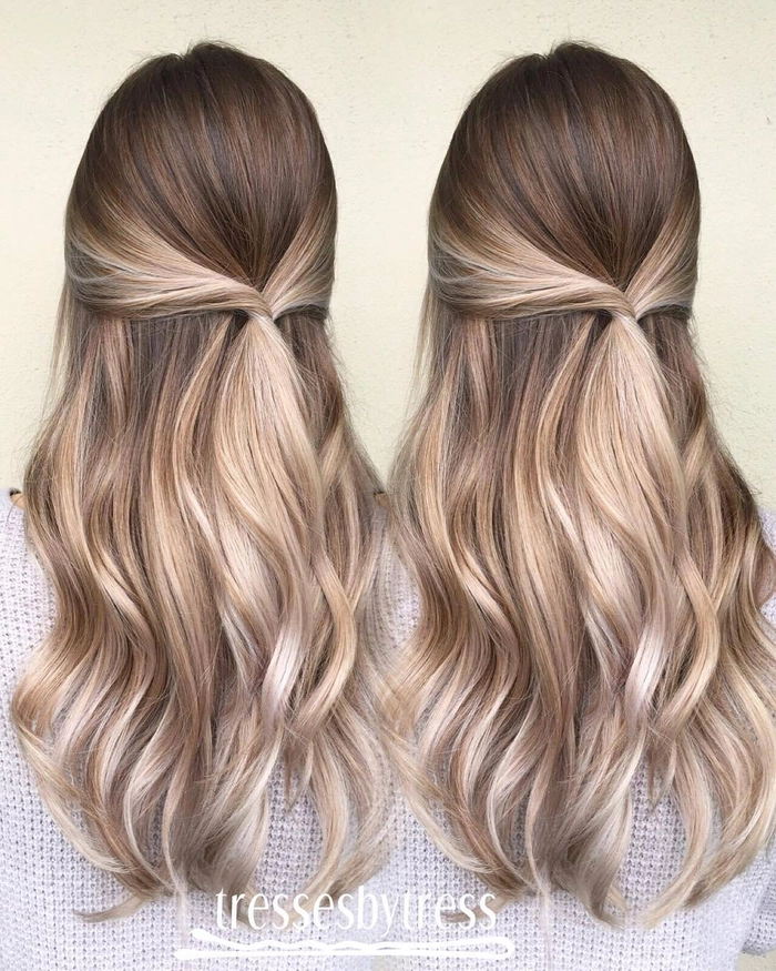 Elegant wedding hair styled for blonde balayage with soft curls and floral accents