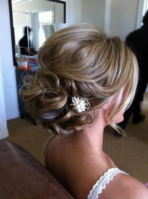 Elegant bridesmaid hairstyle featuring braided details on long hair