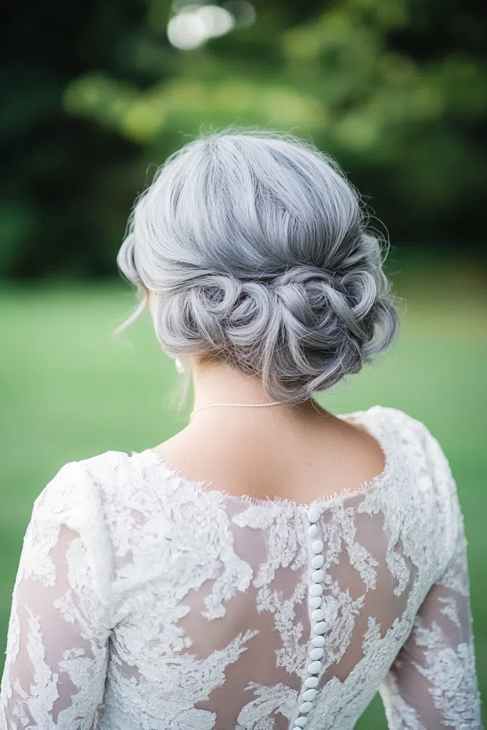 Elegant bridal hair for gray hair styled with soft curls and delicate accessories