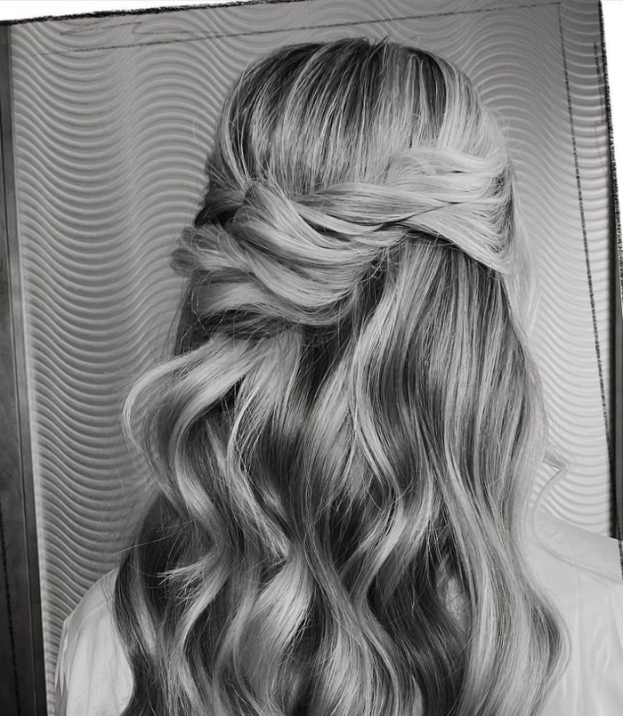 Elegant bridal hair for gray hair styled with soft waves and floral accents