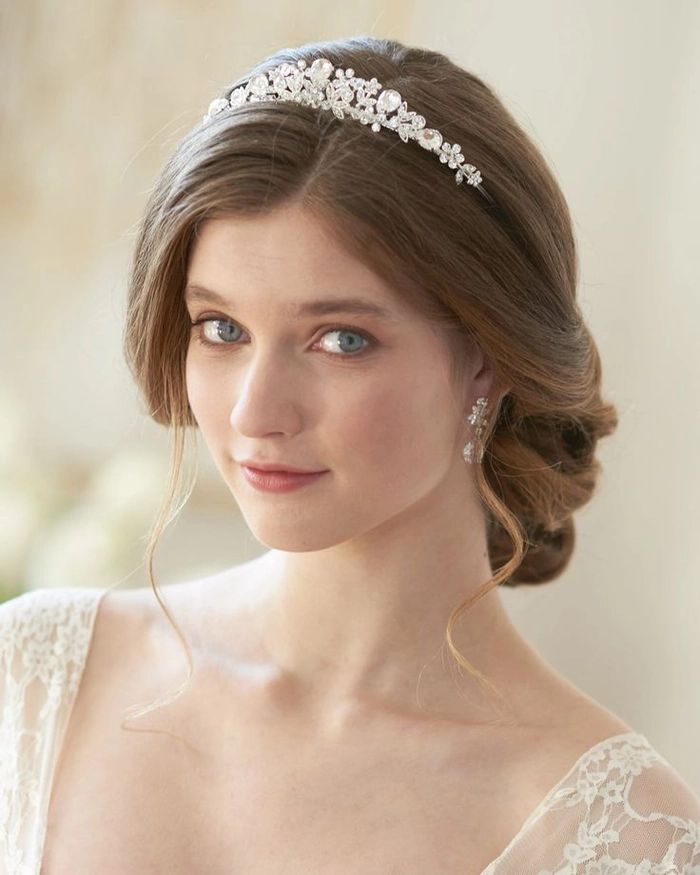 Sophisticated wedding hairstyle featuring a sparkling crystal tiara Elegant wedding hair with crystal tiara styled for a bridal look