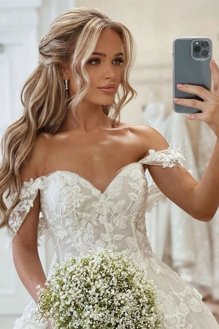 Elegant bridal hair styled to complement an off the shoulder wedding dress