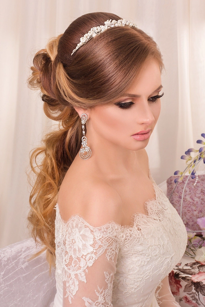 Elegant bridal hair styled to complement an off the shoulder dress for a wedding