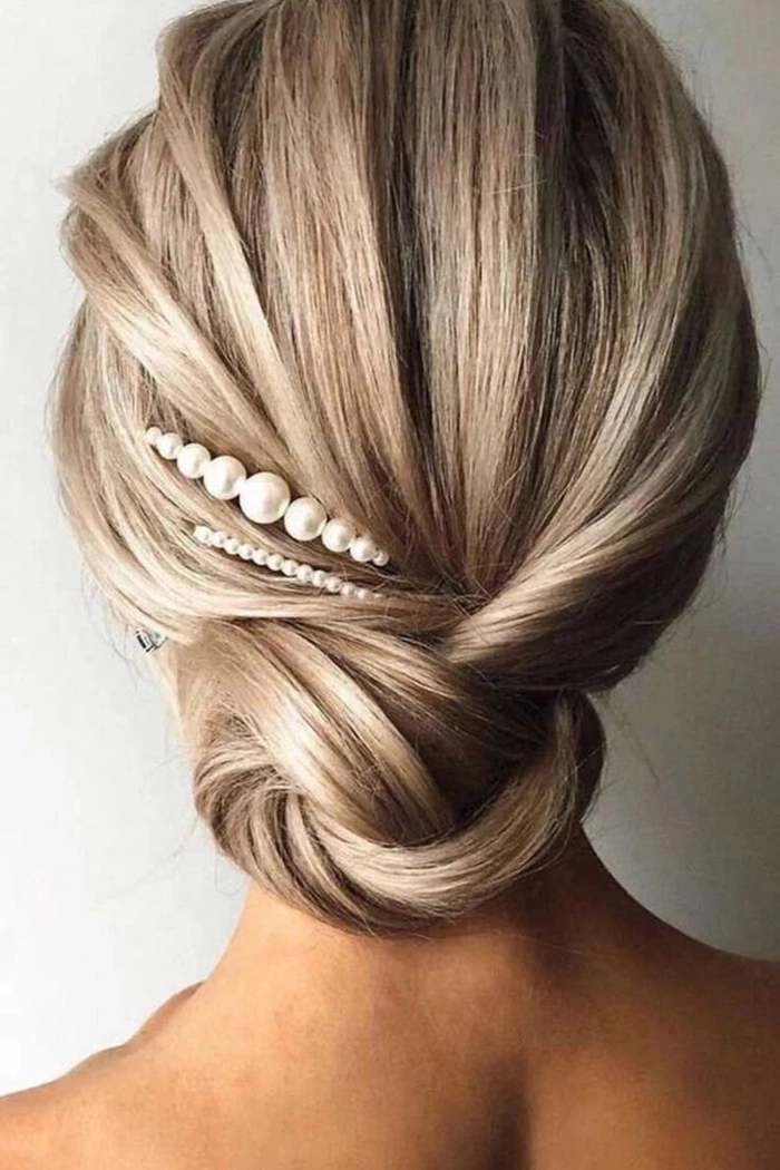 Classic wedding hairstyle featuring pearl hair pins adding a touch of sophistication Elegant bridal hair styled with delicate pearl hair pins for a timeless wedding look