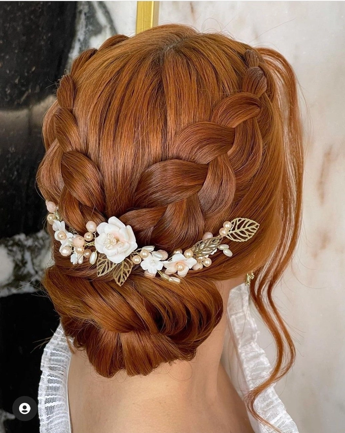 Elegant bridal hair for redheads styled with delicate waves and floral accessories