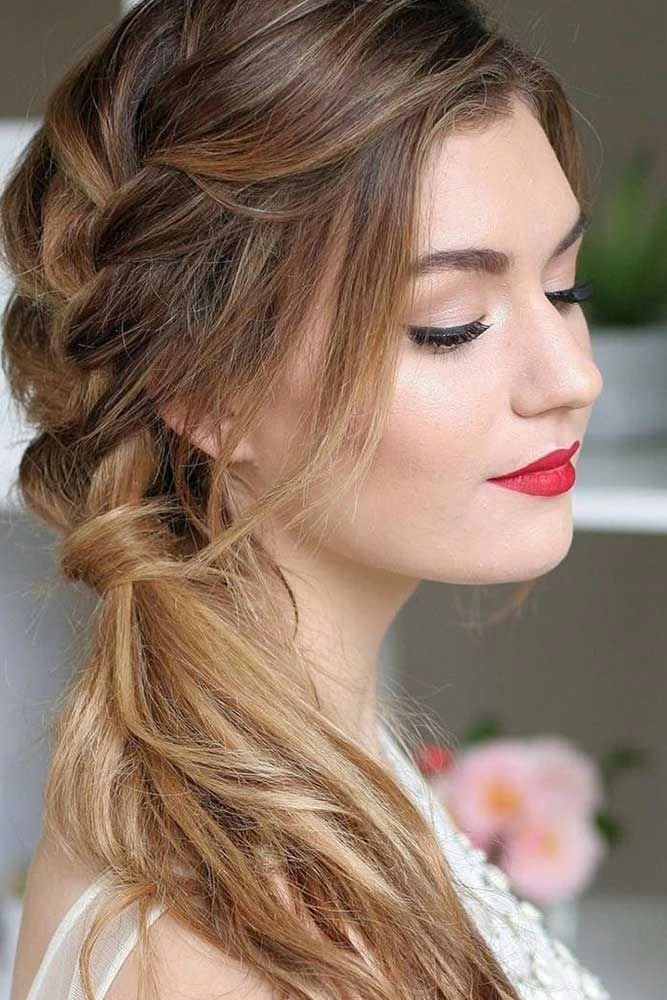 Beautiful wedding hairstyle featuring a side braid for brides Elegant bridal hair with a delicate side braid for a wedding look