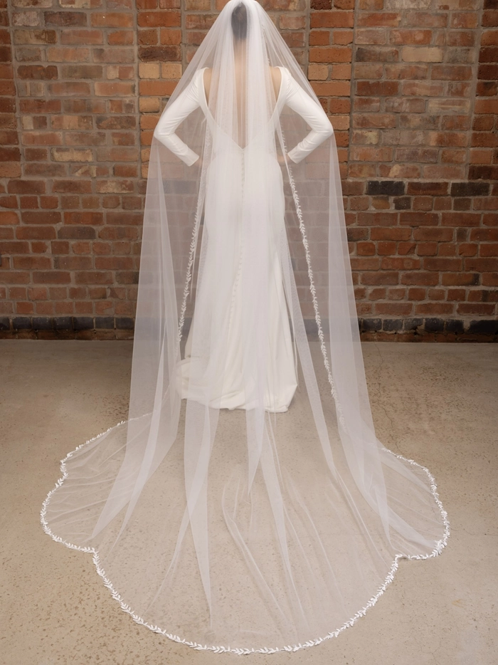 Stunning wedding hairstyle featuring a cathedral veil perfect for the bride's special day Elegant bridal hairstyle complemented by a cathedral veil for a classic wedding look