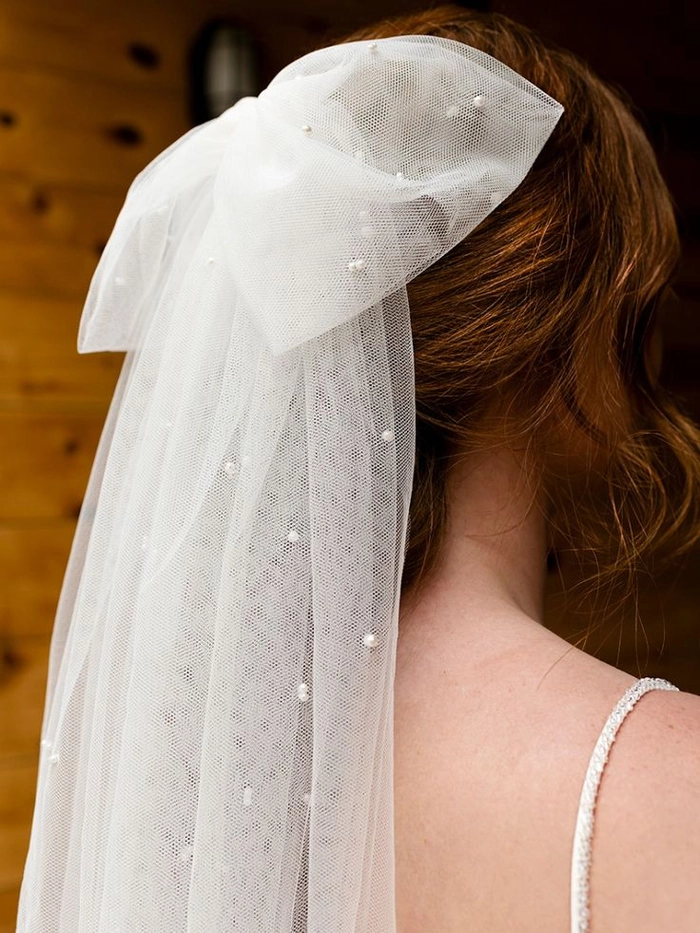 Stunning wedding hairstyle with a cathedral veil for a classic bridal look Elegant bridal hairstyle featuring a cathedral veil flowing over soft curls