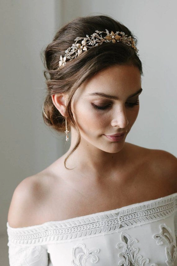 Sophisticated wedding hair with sparkling crystal tiara for brides Elegant bridal hairstyle featuring a wedding hair with crystal tiara