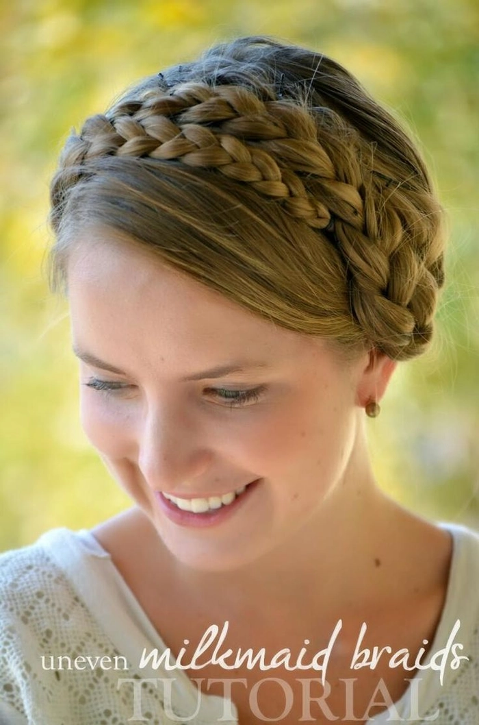 Romantic wedding hairstyle featuring bridal milkmaid braids with soft, effortless waves Elegant bridal milkmaid braids styled with delicate floral accents for a wedding look
