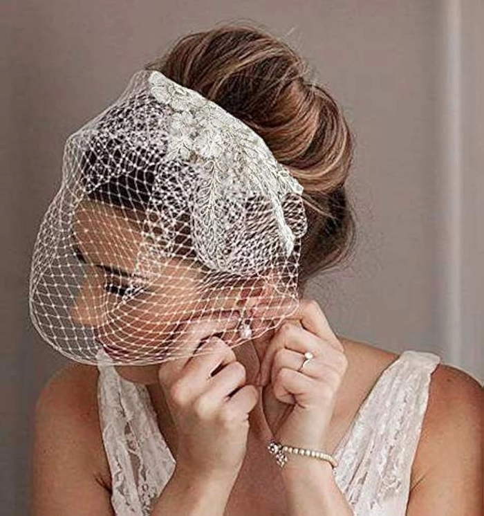 Elegant bridal updo featuring wedding hairstyles with birdcage veil