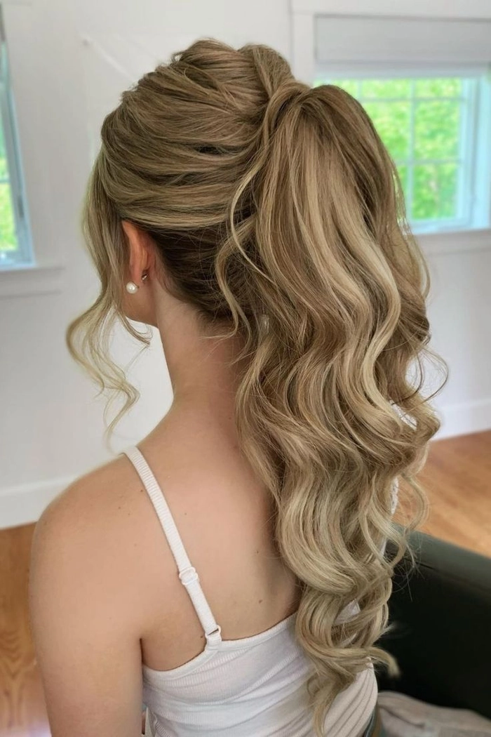 Sleek high ponytail wedding hairstyle perfect for a modern bridal look Elegant bride with sleek high ponytail wedding hair adorned with delicate floral accents