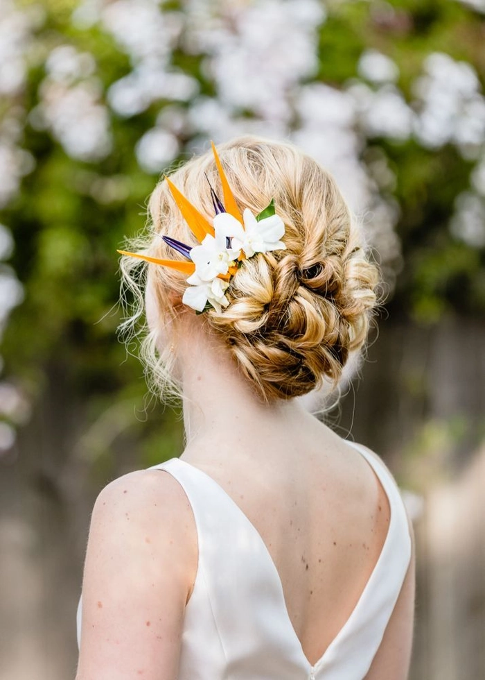 Beautiful tropical wedding hairstyle perfect for a beach ceremony Elegant bride showcasing destination tropical wedding hair with floral accents