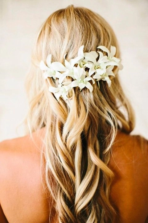 Beautiful tropical wedding hairstyle perfect for destination weddings Elegant bride with destination tropical wedding hair styled with flowers