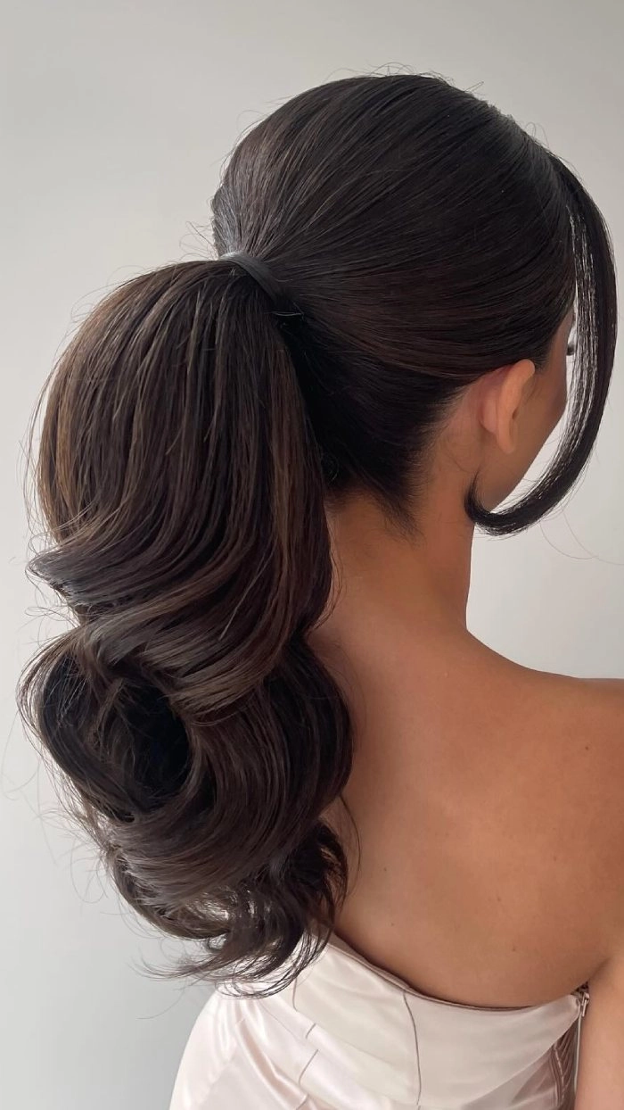 Classic and polished sleek high ponytail for wedding hairstyles image 13 Elegant bride with a sleek high ponytail wedding hair style