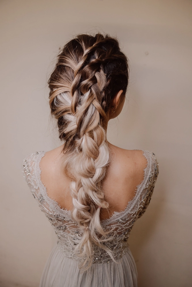 Elegant bridesmaid hairstyles for long hair featuring soft curls and delicate floral accents