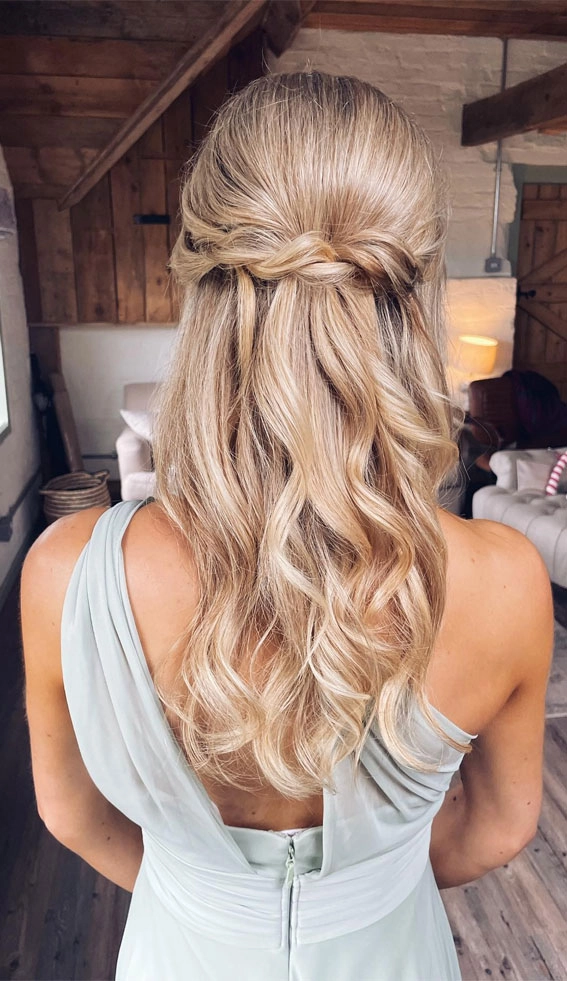 Elegant bridesmaid hairstyles for long hair featuring soft curls and floral accents