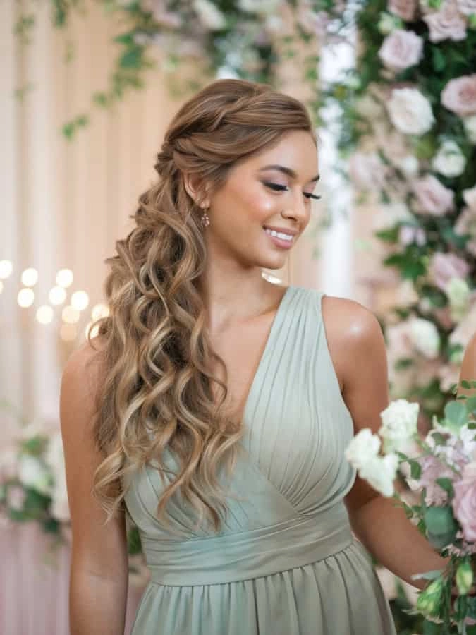 Beautiful bridesmaid half up half down style perfect for wedding day glamour Elegant bridesmaid with half up half down hairstyle featuring soft waves
