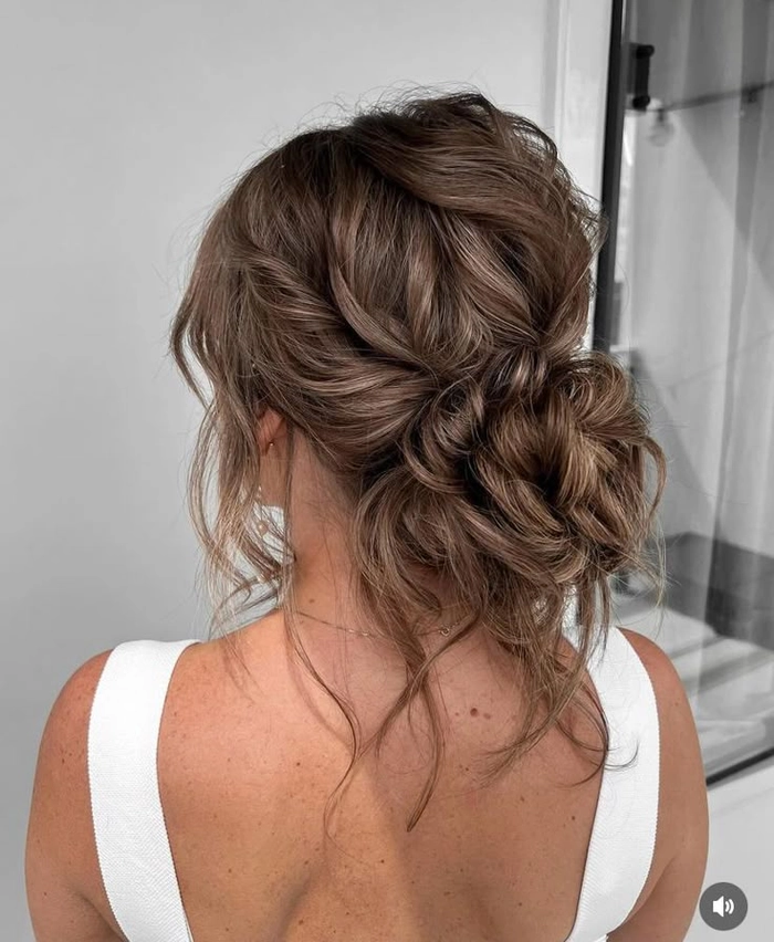 Bridal look featuring a beautiful brunette hairstyle with subtle highlights for depth Elegant wedding hairstyle showcasing rich brunette dimension with soft curls