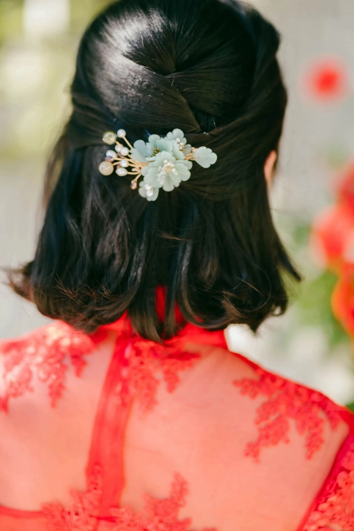 Elegant Chinese wedding hair styled with traditional hair sticks for a bridal look